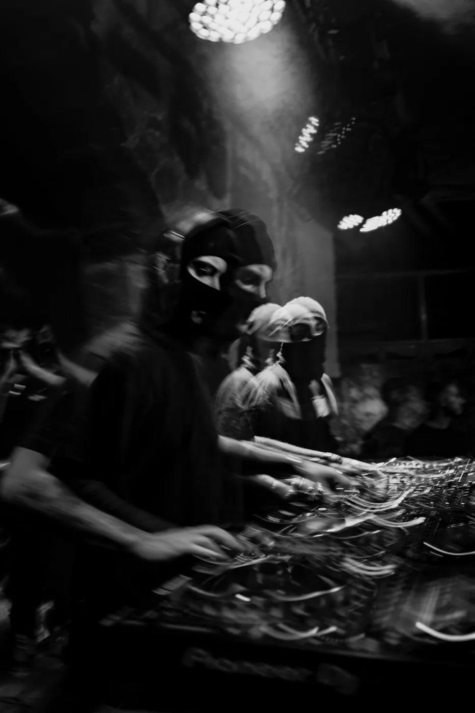 DJ performing under stage lights in motion