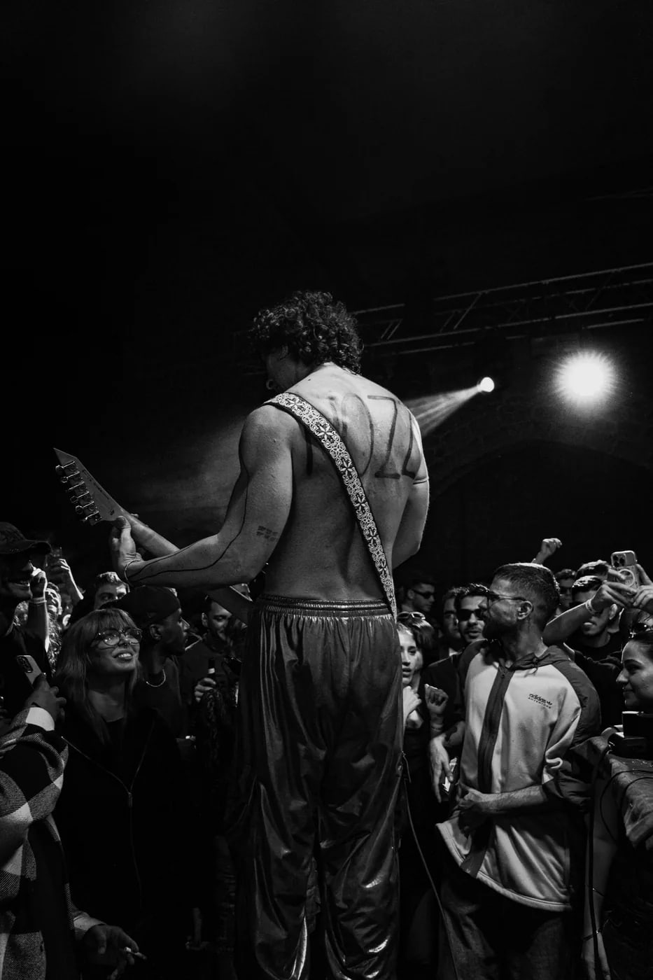 Guitarist performing in the middle of a crowd